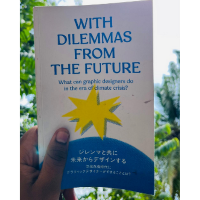 Book titled 'With Dilemmas from the Future' held in front of a blurred natural background